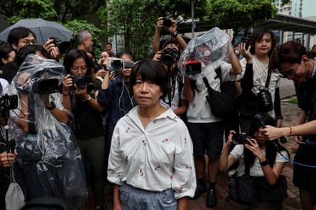 A woman surrounded by media and people