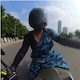 Woman biker rides along Delhi roads in a saree, men cheer her on and make way