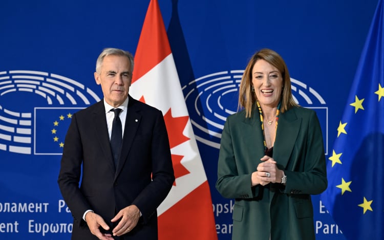 Canadian Prime Minister Mark Carney (L) delivers a speech next to European Parliament President Roberta Metsola in the hemicycle of the European Parliament in Strasbourg, eastern France.